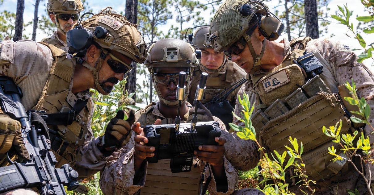 U.S. Marine Corps Sgt. Idris Idris, center, a small unmanned aircraft systems specialist with U.S. Marines with 1st Battalion, 2nd Marine Regiment, 2nd Marine Division, demonstrates the C100 drone capabilities to a Spanish marine during a company live-fire range as a part of Fleet Exercise 250 (FLEETEX) on Marine Corps Base Camp Lejeune, North Carolina, June 19, 2026. FLEETEX 250 represents the United States’ commitment to layer defense of the homeland through forward-deployed forces and reinforces interoperability with allies and partners through collective maritime security. (U.S. Marine Corps photo by Cpl. Channah Chilton)